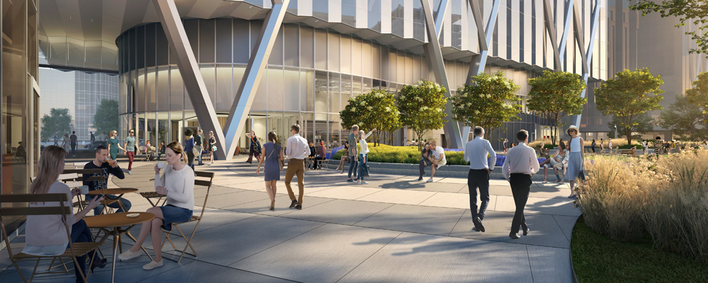 Patrons use the sidewalk and sitting area outside the entrance of 320 S Canal