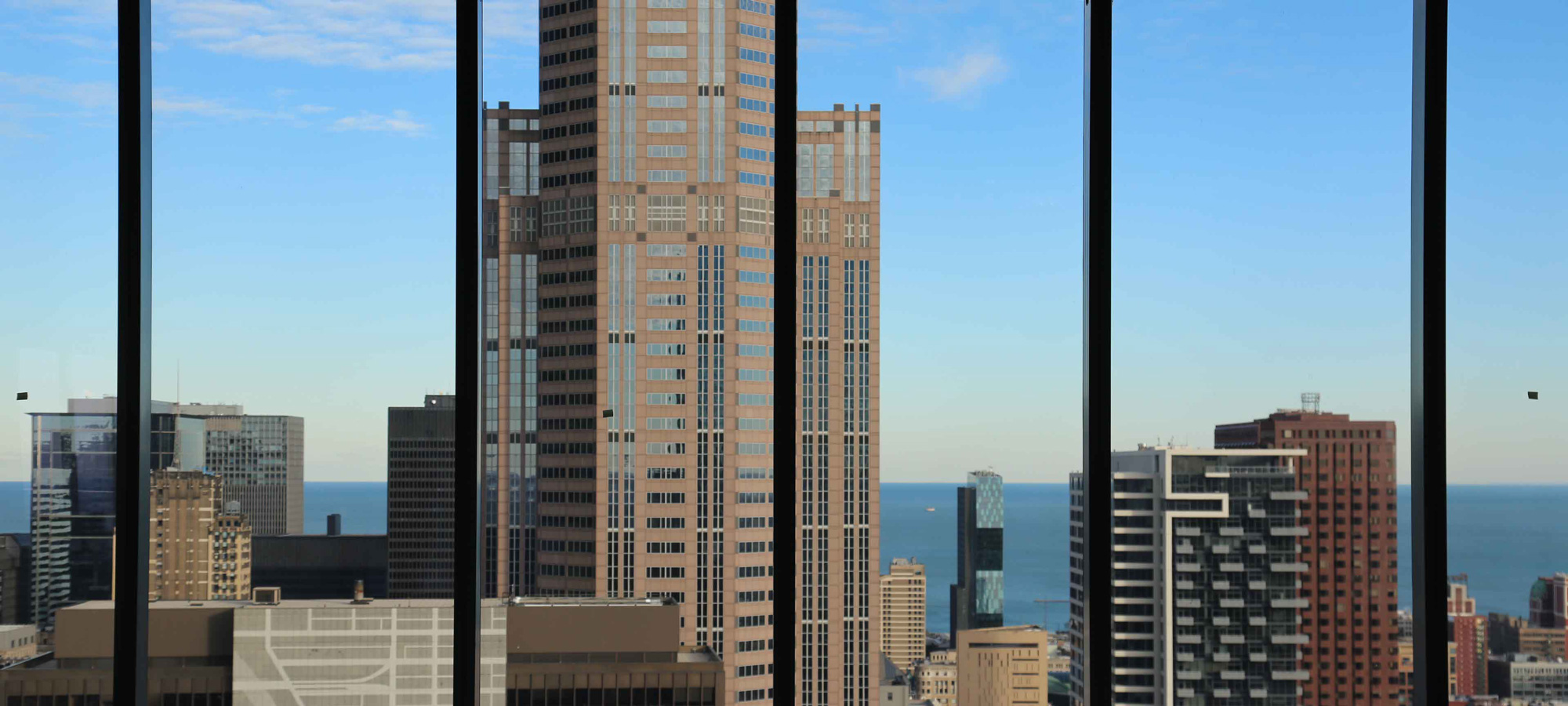 A window view of looking out a large cityscape in the afternoon