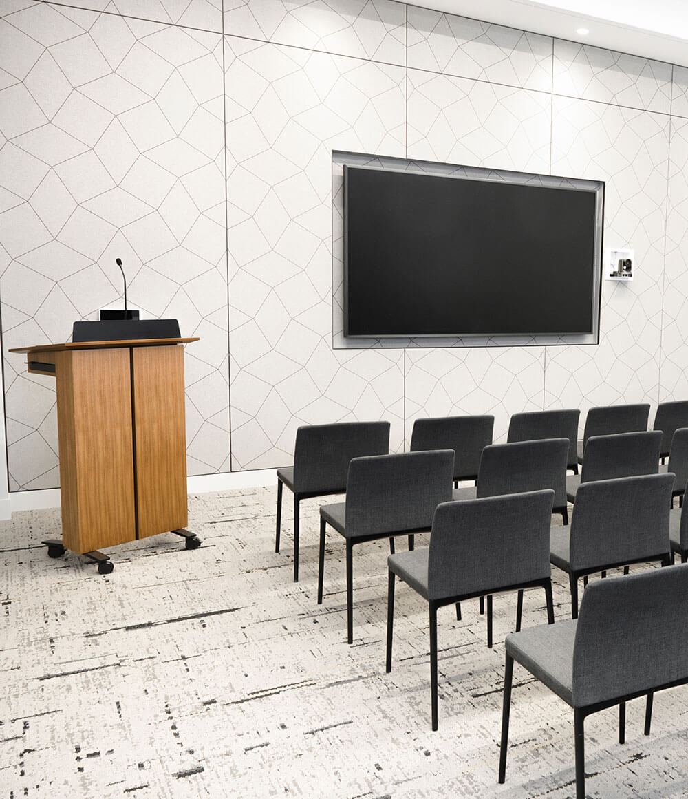 A event space with black chairs and a speaking podium