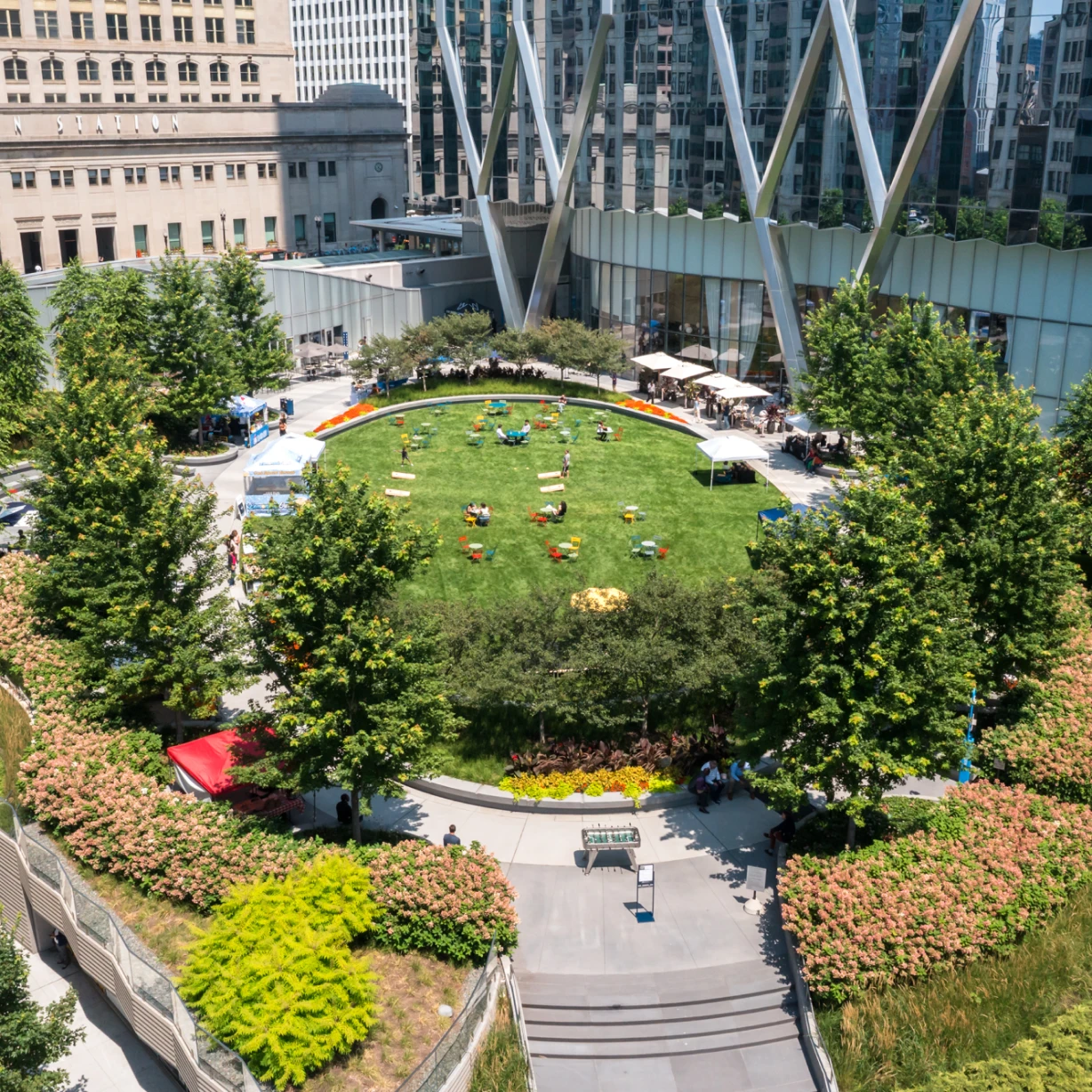 A spacious green outdoor event space with designer landscaping